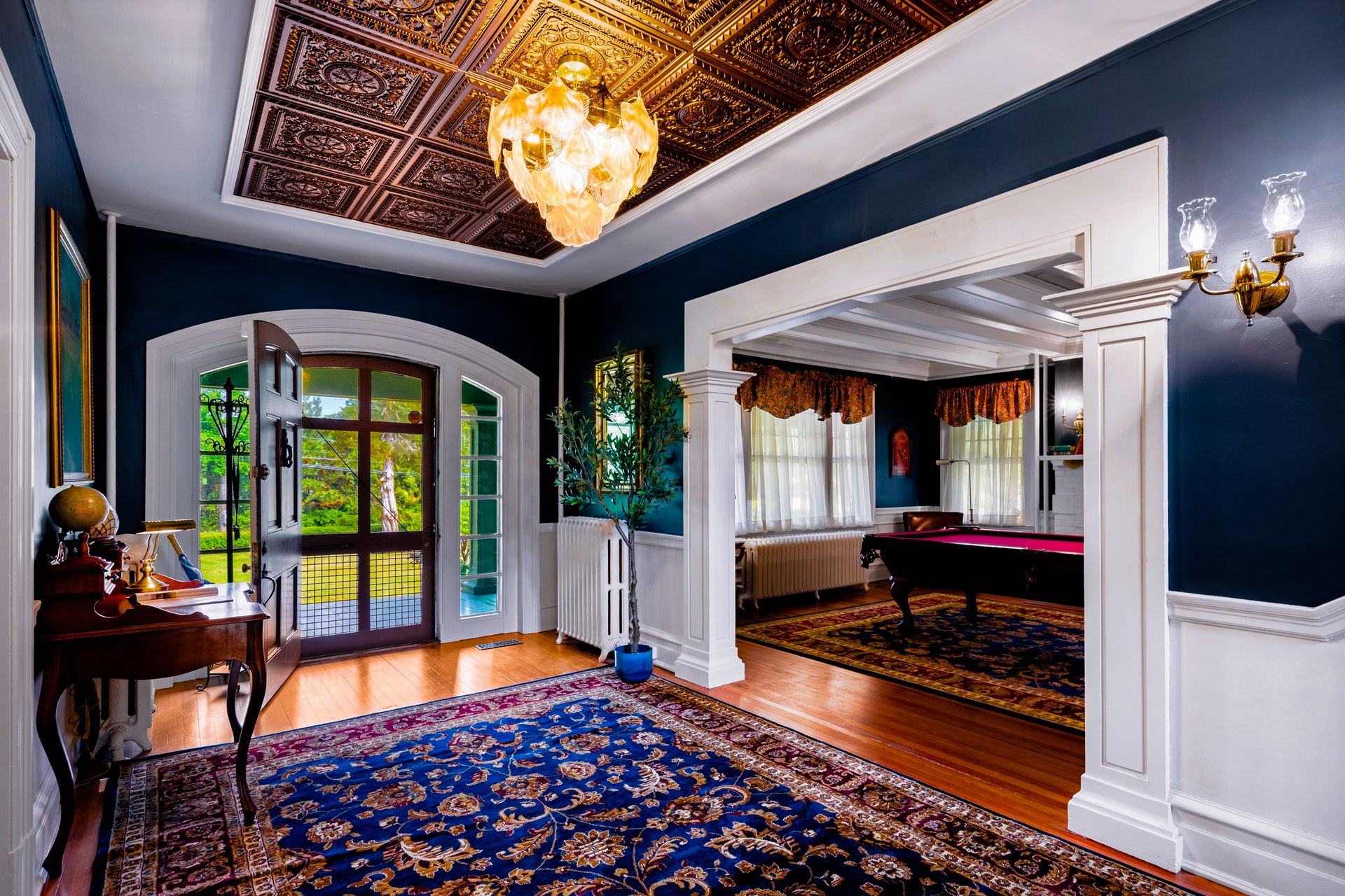 Foyer detail with arched French doors and globe