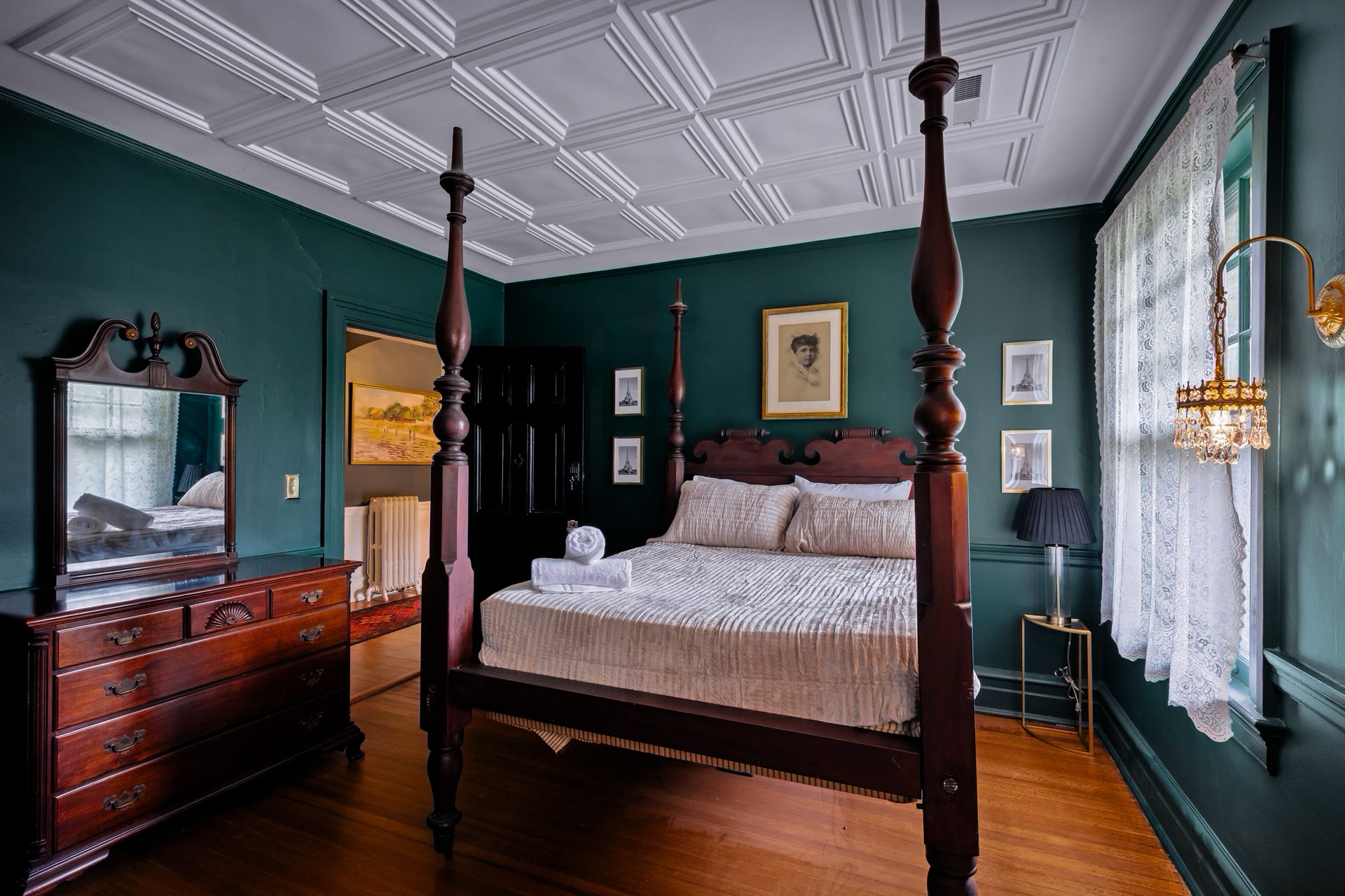 Deep green bedroom with four-poster bed