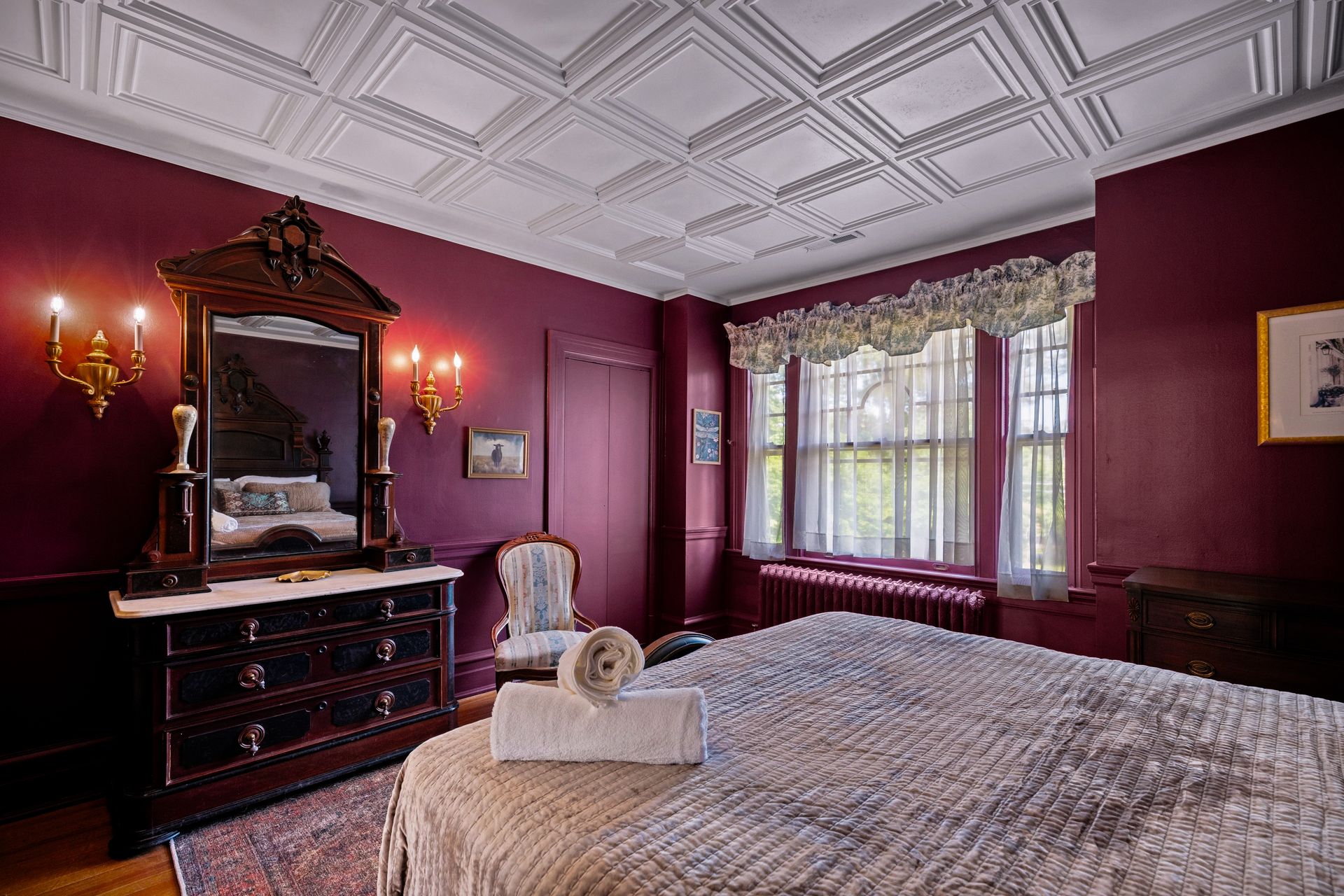 Burgundy bedroom with antique vanity