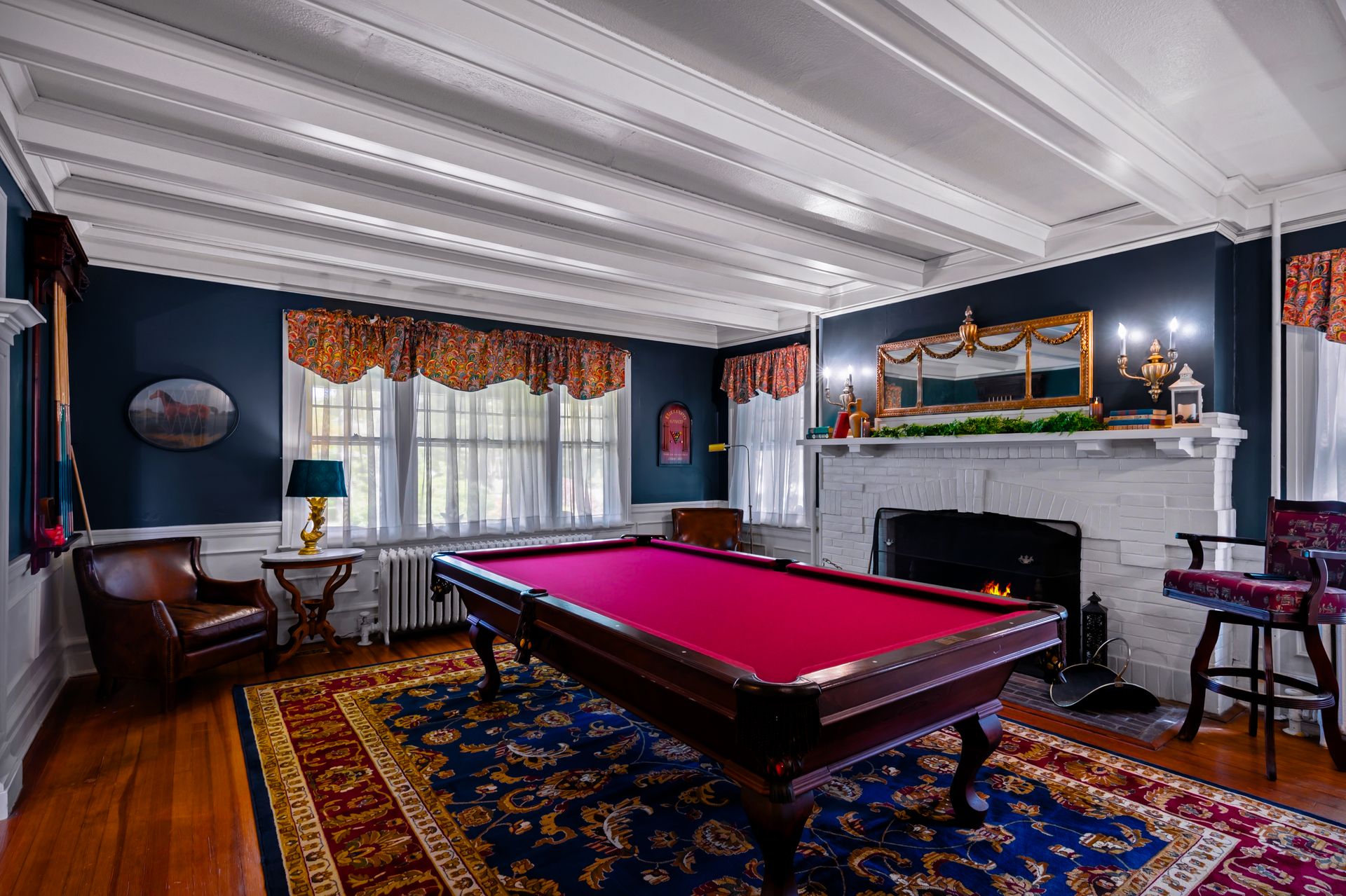 Billiard room with red felt table and charcoal walls