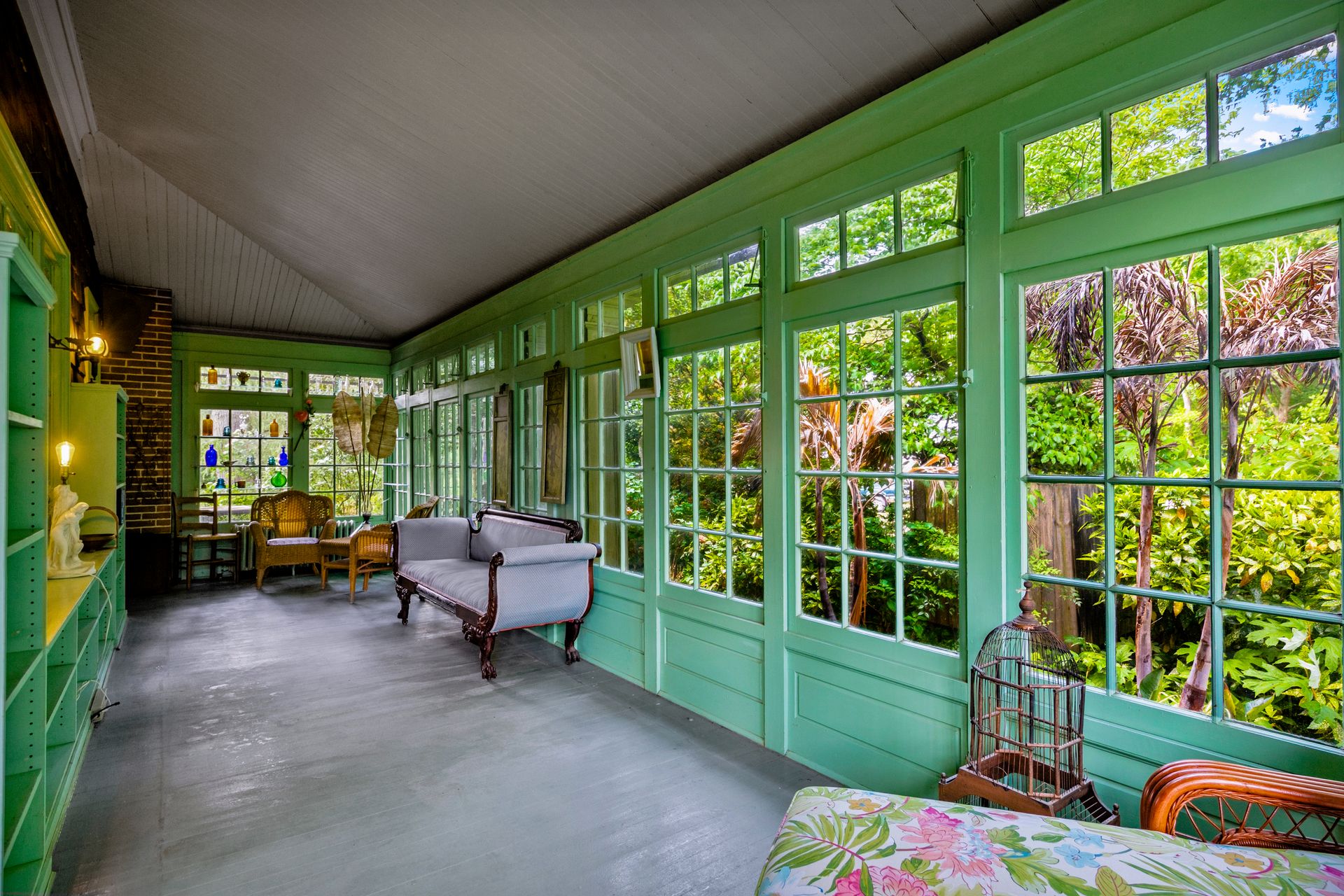 Glass-enclosed sunroom with garden views