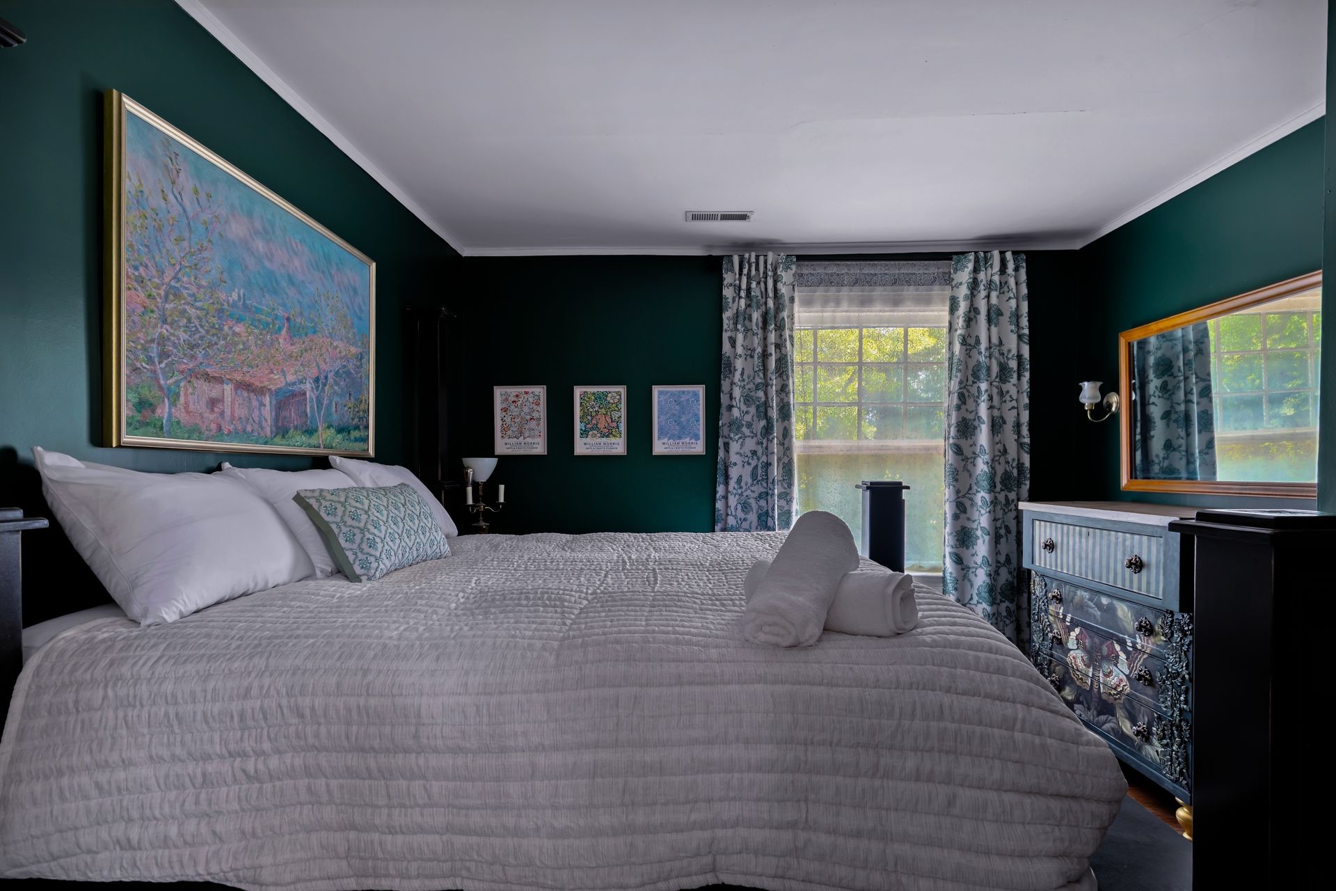 The Ivy Room — deep green walls with landscape art